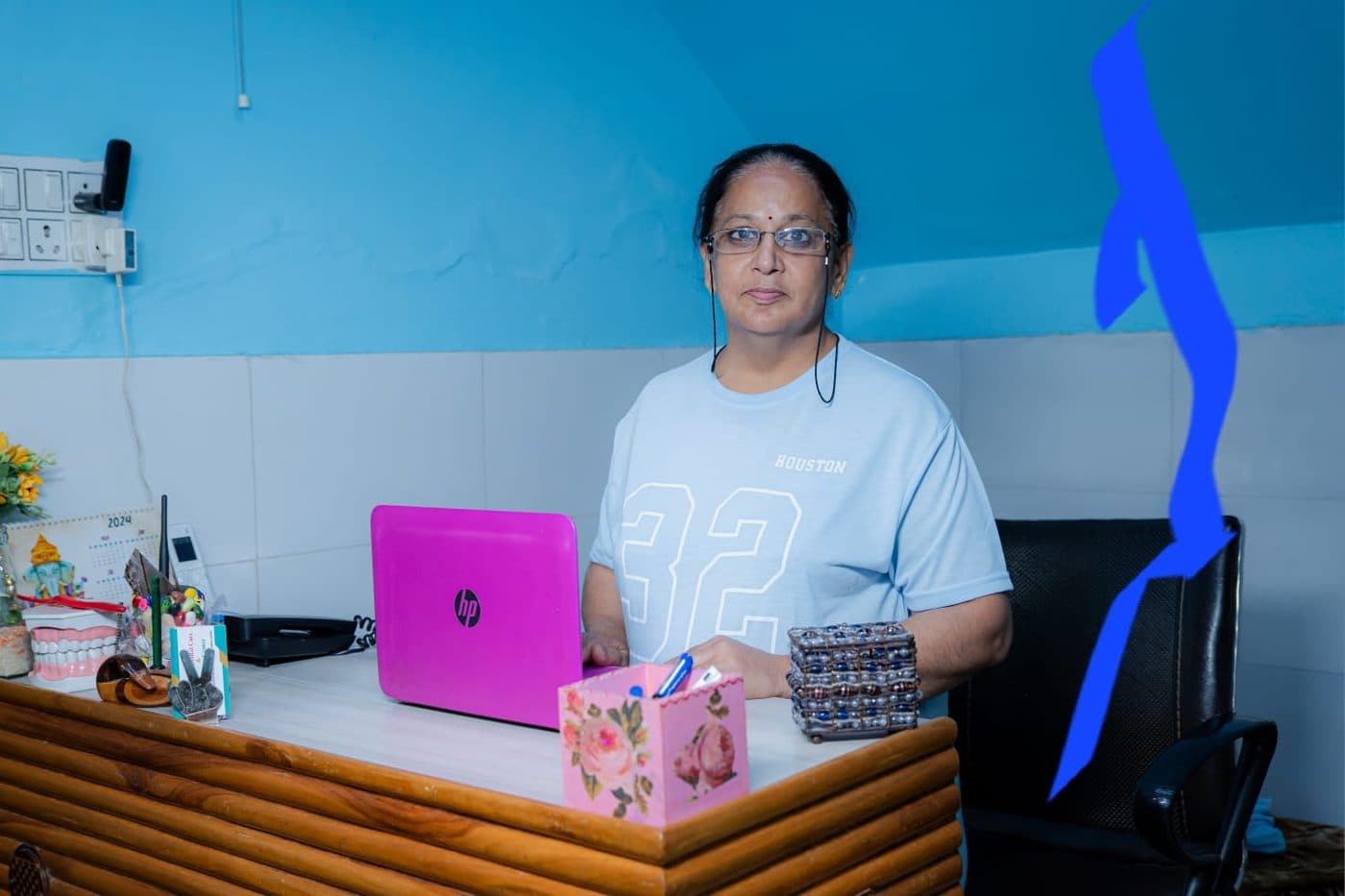 The reception desk at Pain-Off Dental Care, with a receptionist at the computer