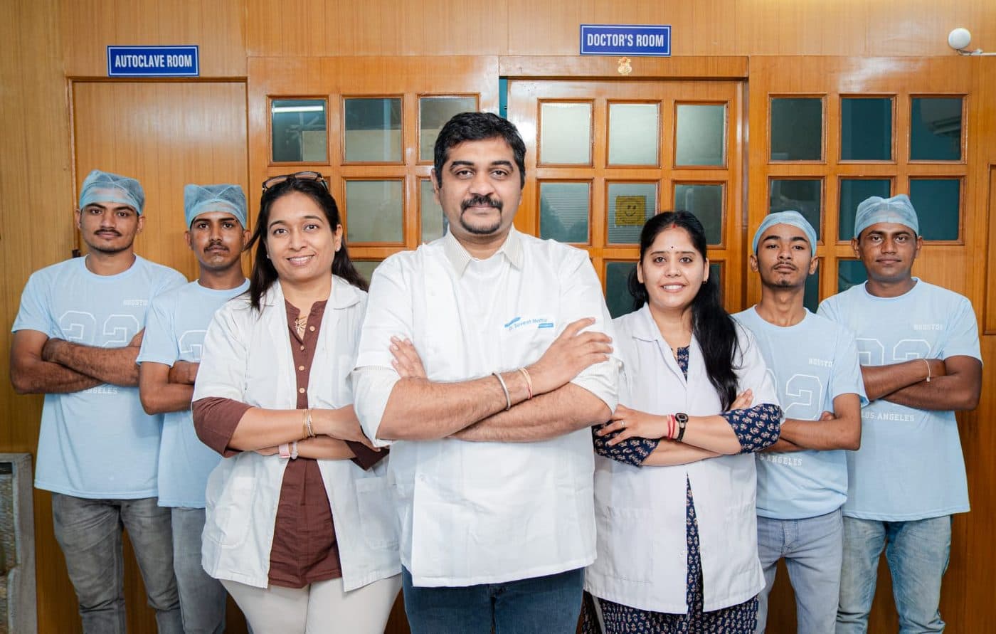 The full team at Pain-Off Dental Care standing together outside the treatment rooms